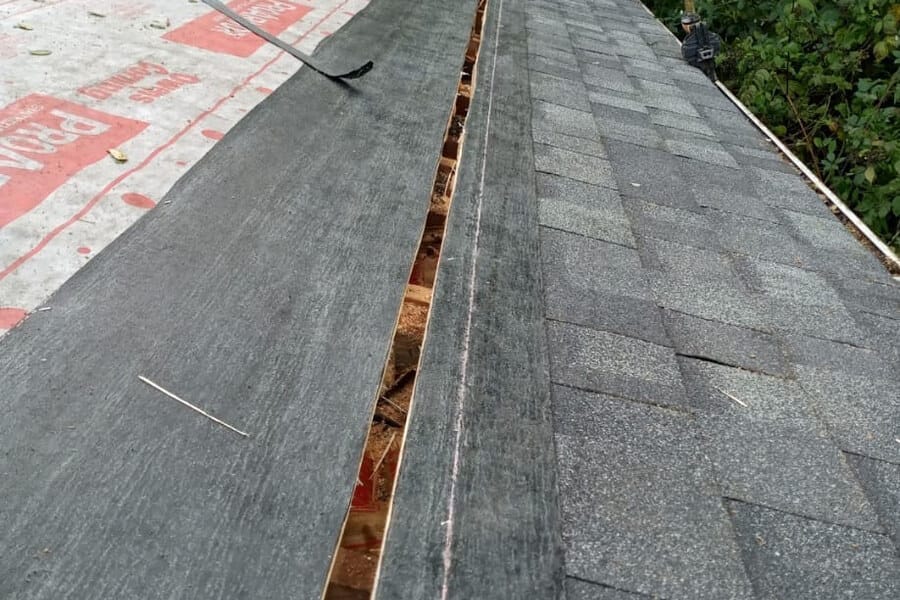 A roof ridge with the sheathing cut open along its length to take a ridge vent.